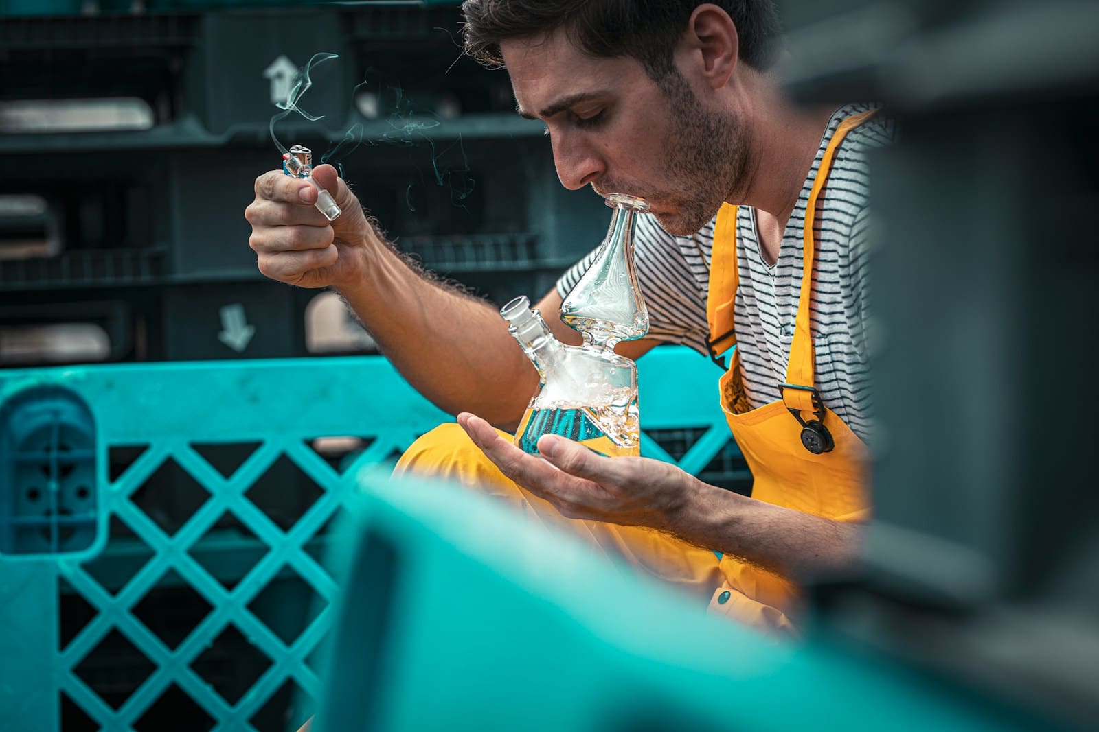 man using glass smoking device