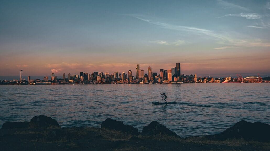 a person riding a paddle board on a body of water