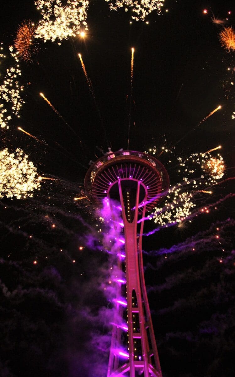 fireworks are lit up in the sky above the Space Needle
