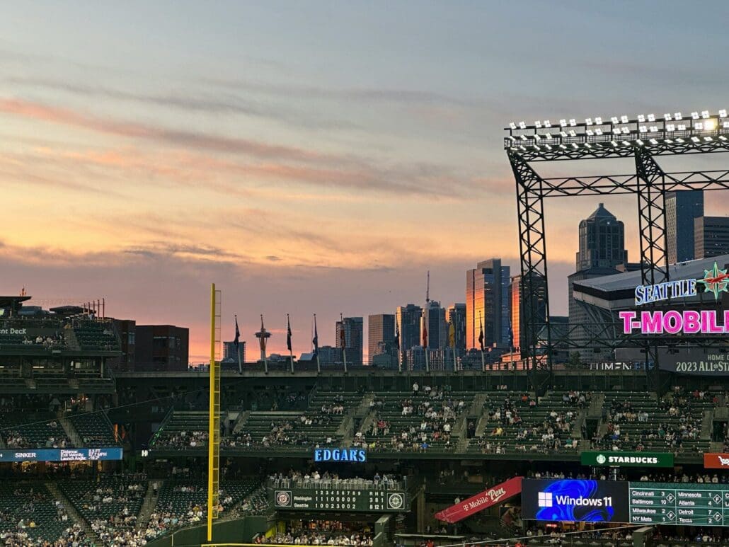 a baseball stadium with a view of the skyline