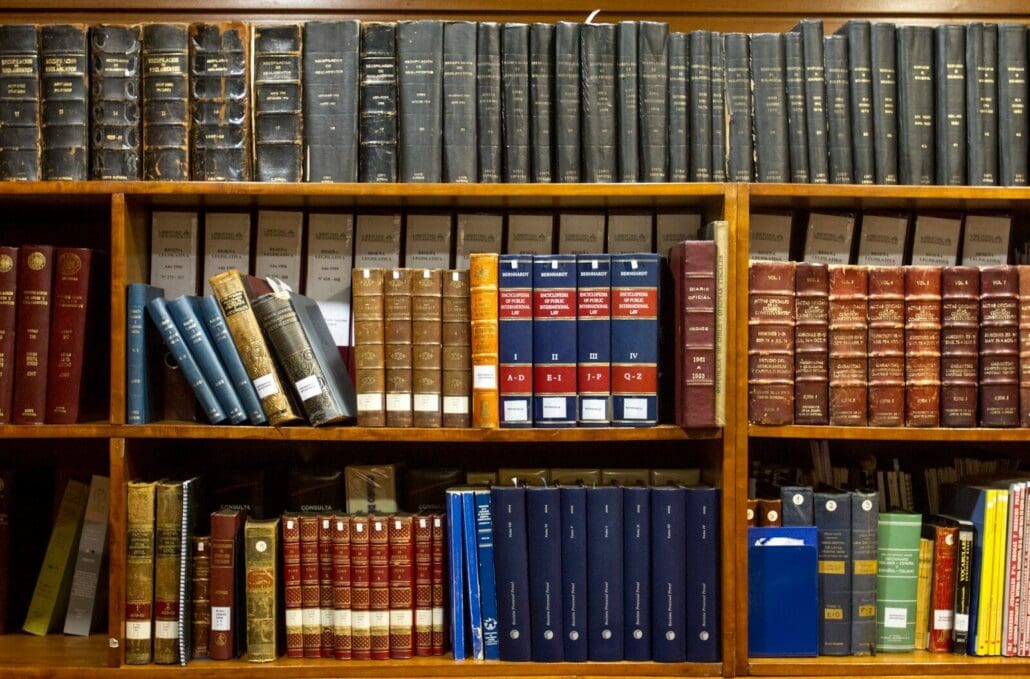 a bookshelf filled with lots of law books on top of wooden shelves. Missouri cannabis laws are still being written