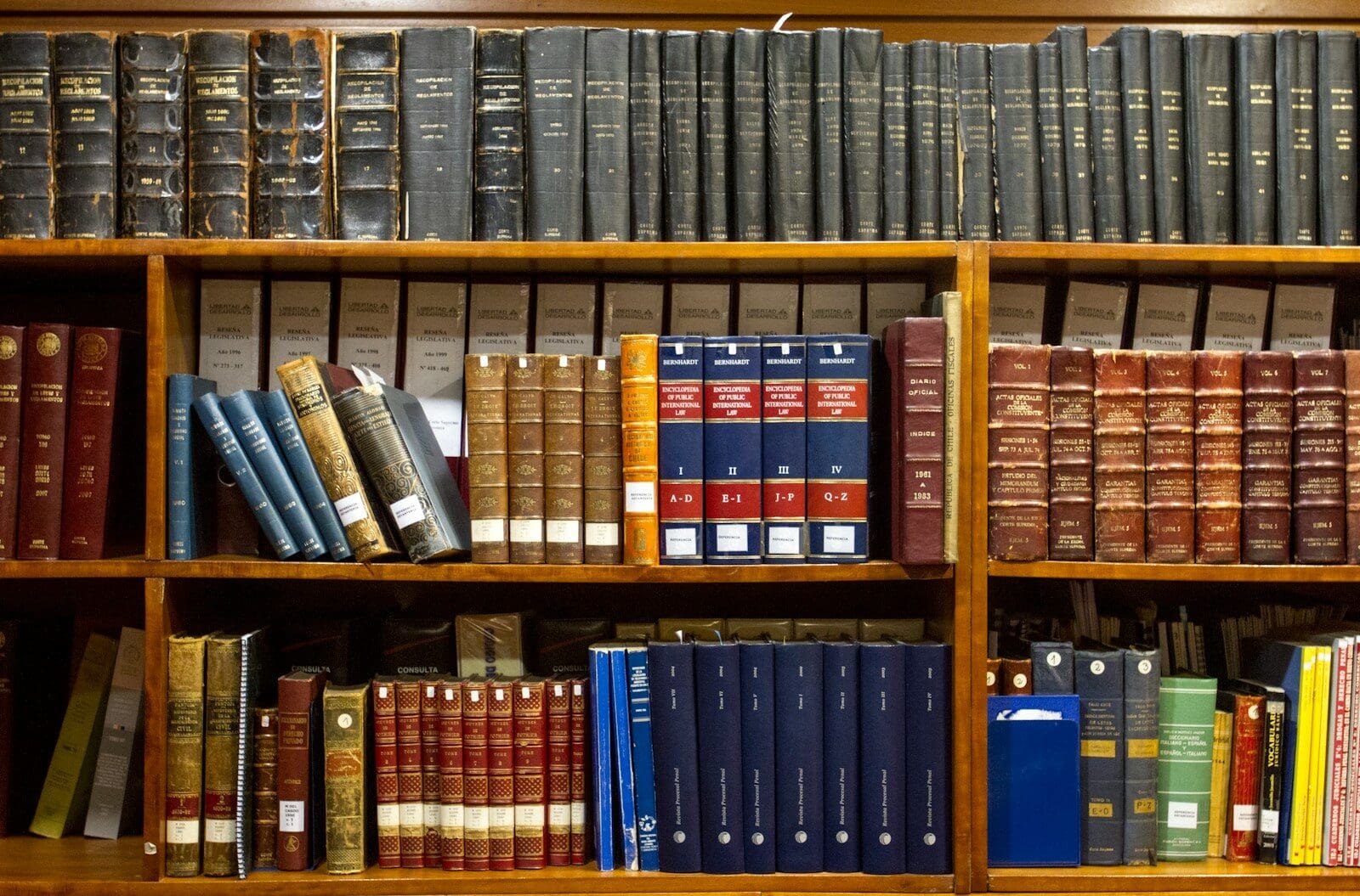 a bookshelf filled with lots of law books on top of wooden shelves. Missouri cannabis laws are still being written