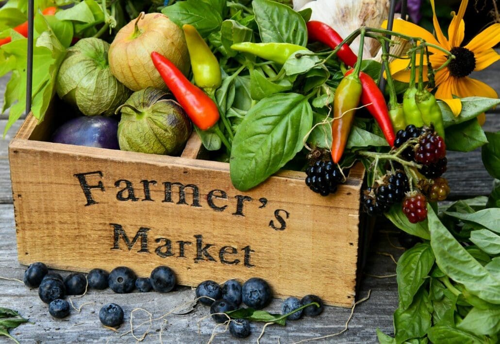 fruit and vegetables in a wooden crate that says farmer's market