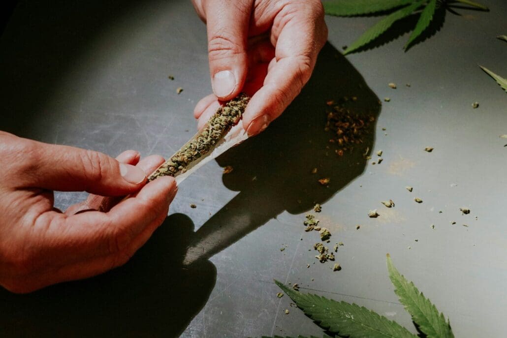 person rolling a marijuana joint at SODO Kush21