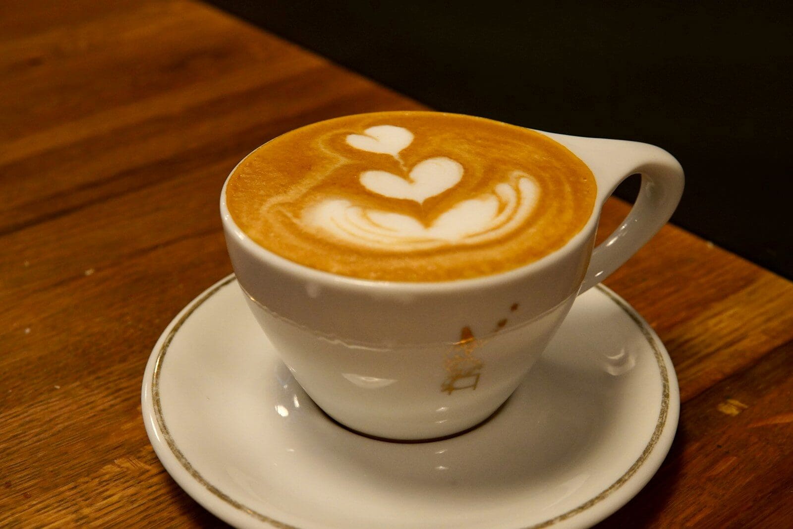 a cup of coffee with heart shaped latte art on top